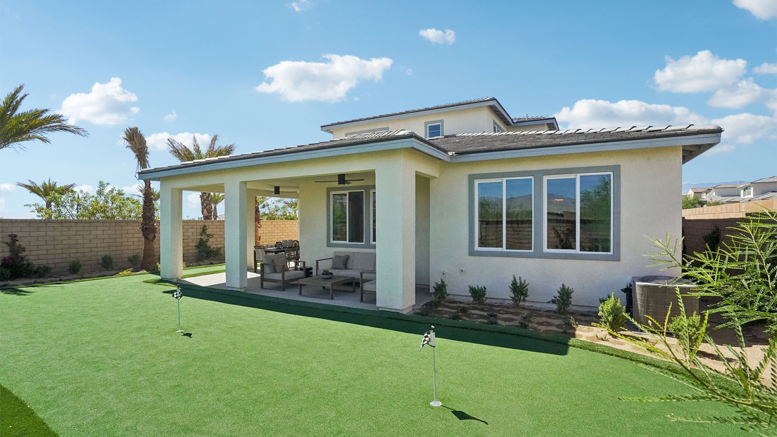 Two story Desert California home with turf backyard and covered California Room