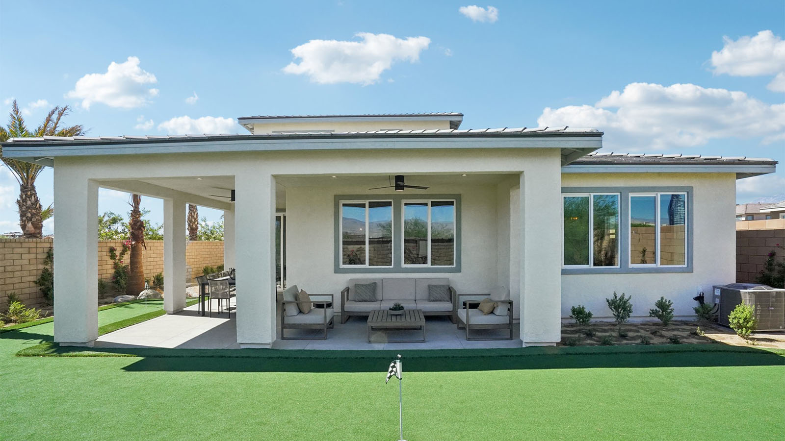 Two story Desert California home with turf backyard and covered California Room