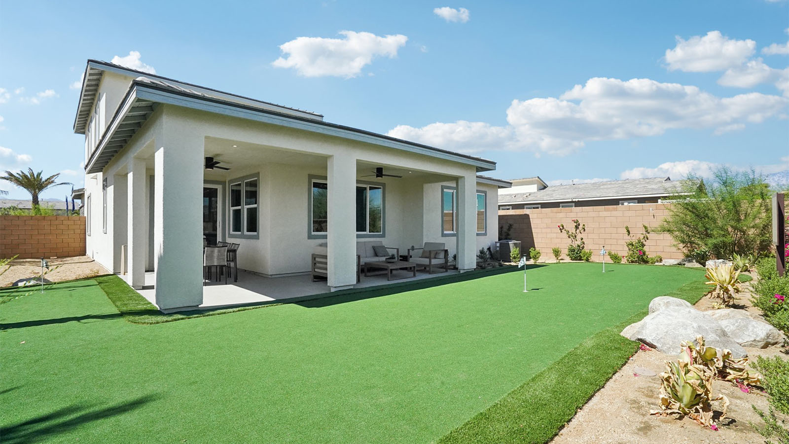 Two story Desert California home with turf backyard and covered California Room
