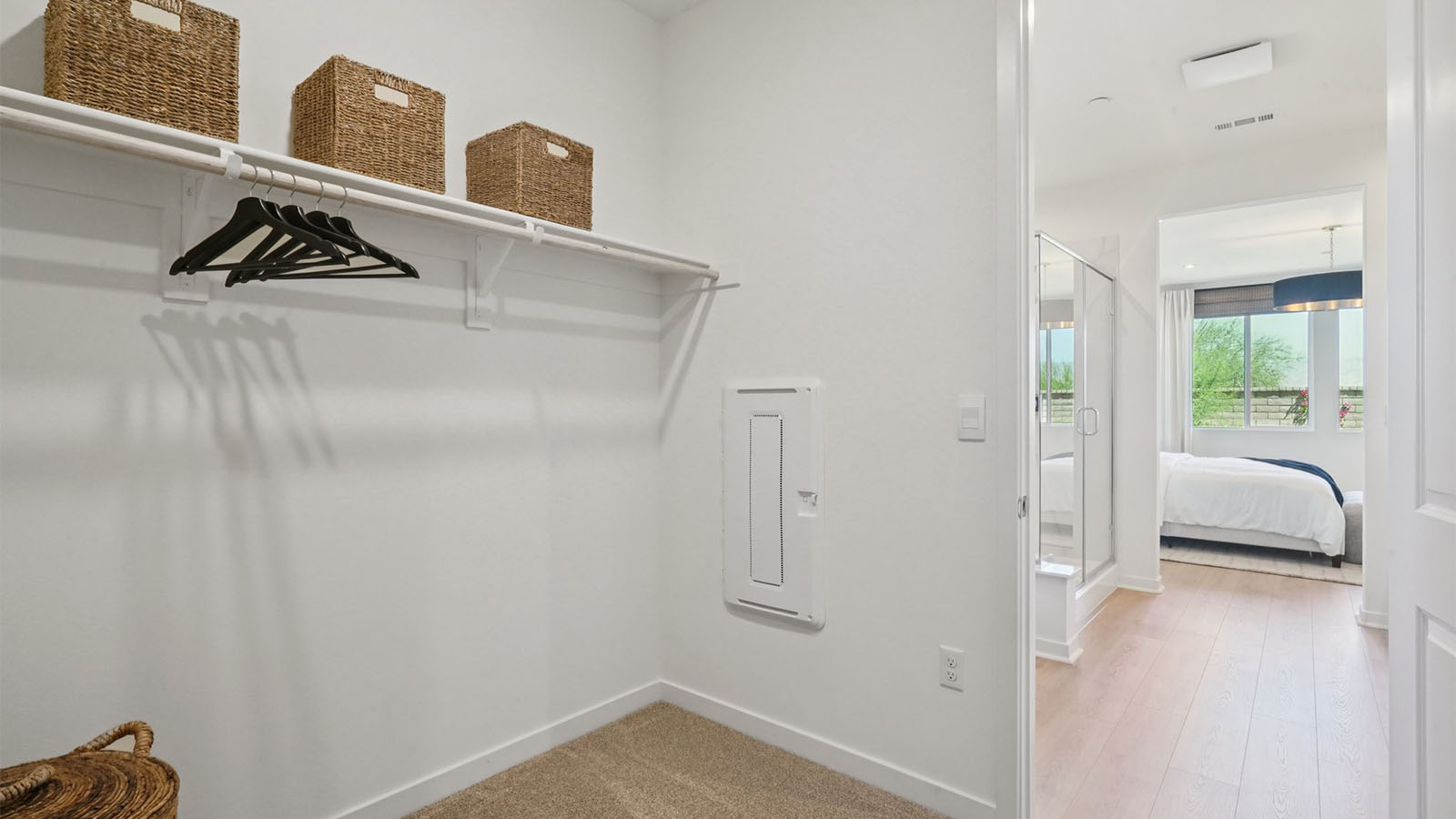 Primary bathroom with dual vanities and walk-in closet