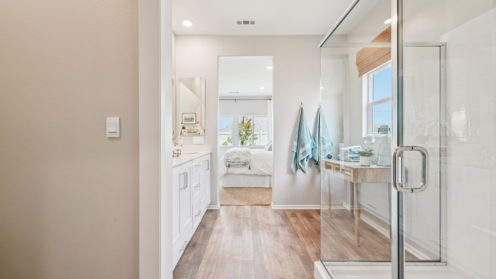 primary bahtroom with dual vanities and walk in shower