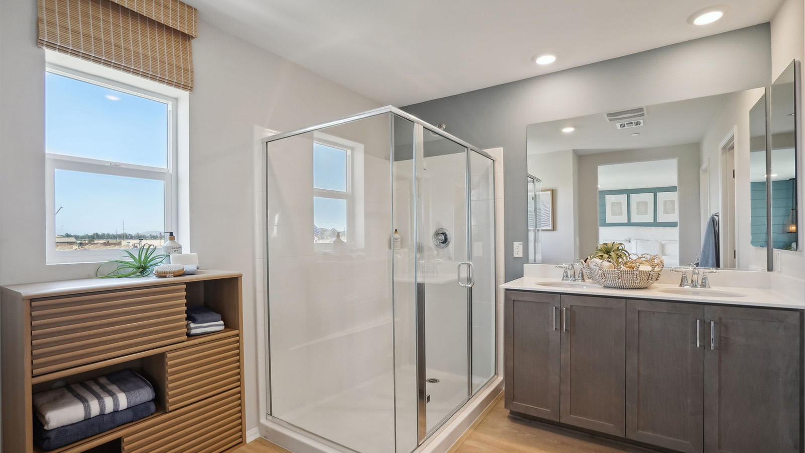 primary bathroom with dual vanities and walk in shower