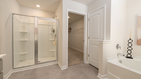 Primary Primary Bath with separate tub and shower with grey cabinets