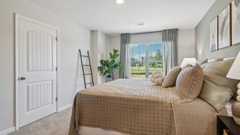 Primary suite with walk in closet in the front exterior of the home