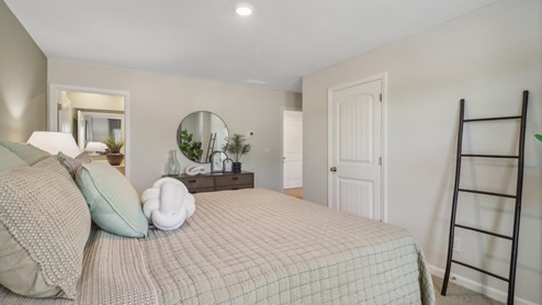 Primary suite with walk in closet in the front exterior of the home