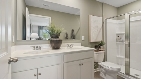 Primary Bath with LVP flooring and white marble coutertops