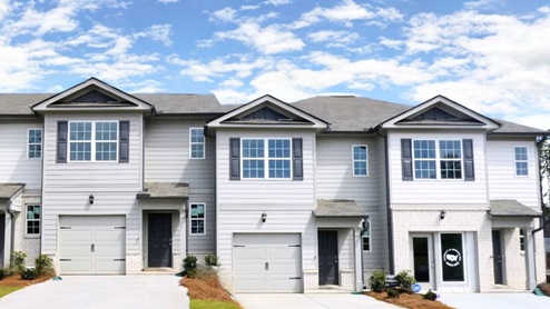 2 Story Townhome with grey siding and 1 car garage