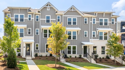 3 Story exterior townhome with grey exterior and 2 car garage