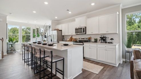 White cabinets with white quartz countertops and subway tile