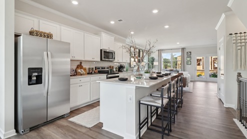 White cabinets with white quartz countertops and subway tile