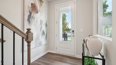 Main level on the townhome with LVP flooring and bedroom on the main