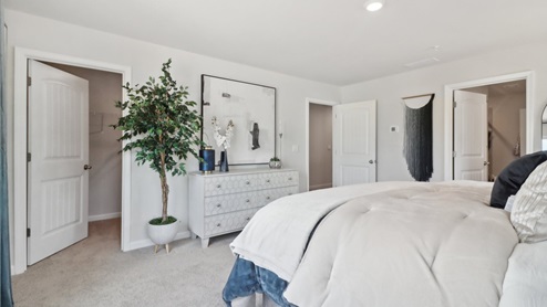 Spacious primary suite with walk in closet and oversized bath