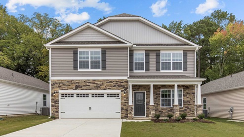 Two story home with two car garage and bedroom above garage