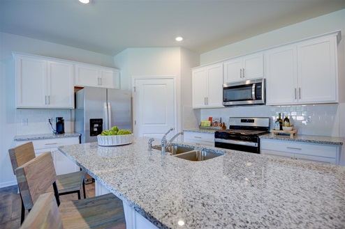 Kitchen with white cabinets and granite countertops