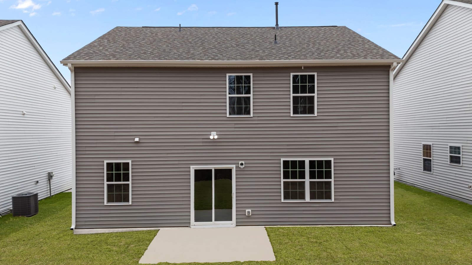 rear exterior photo of two story home with brown siding