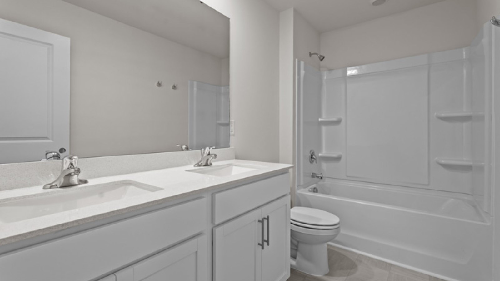 bathroom with double sinks and bath and tub