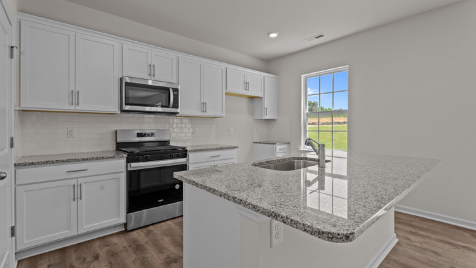 kitchen area with white cabinets and stainless steel appliances