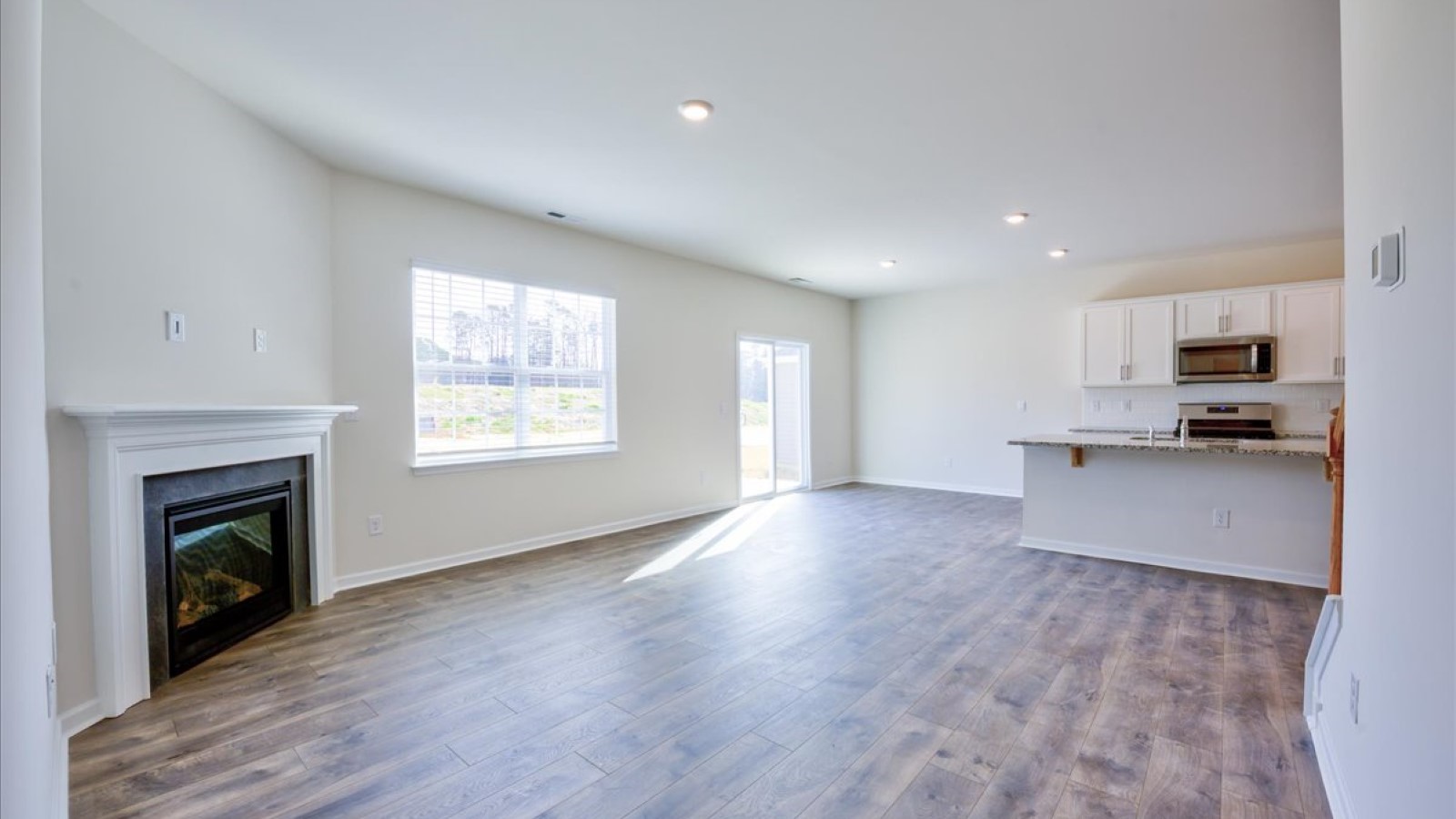 Living room with fireplace and revwood flooring