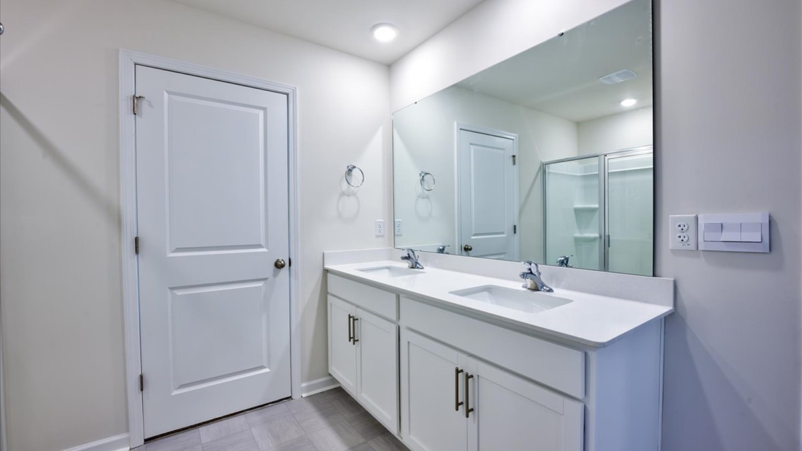 Primary bathroom with quartz counters and double sinks