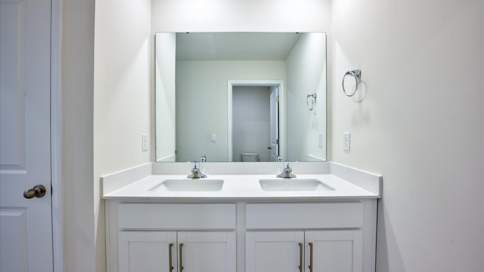 Bathroom with quartz counters and double sinks