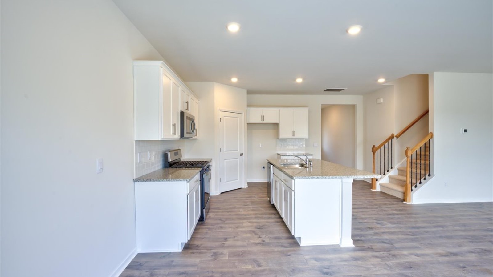kitchen area with island and stainless steel appliances