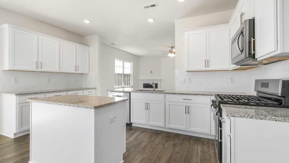 kitchen area with island and white cabinets