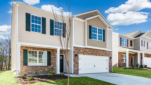 Two story home with two car garage and front door on the left