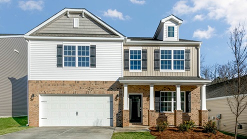 Two story home with two car garage and bedroom above garage