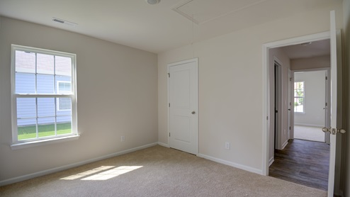 large bedroom with closet and carpet flooring