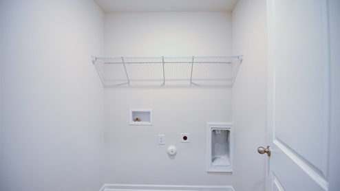 laundry room with built in wire shelving