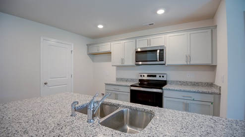 large kitchen with island and granite countertops and stainless steel appliances