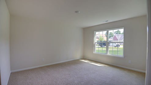 Bedroom with carpet flooring and window for natural light