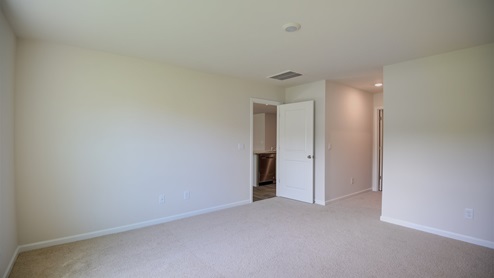 Bedroom with carpet flooring and window for natural light