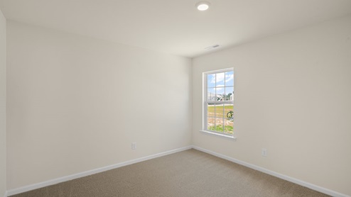 large bedroom with carpet flooring and window for natural light