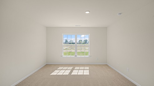 large bedroom with carpet flooring and window for natural lighting
