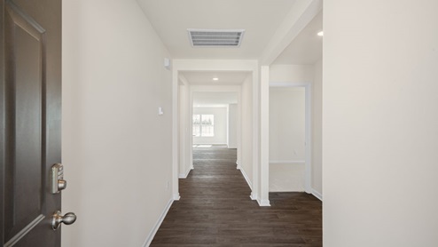 Foyer with white walls and dark floor