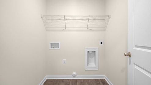 laundry room with washer and dryer hookups and built in wire shelving