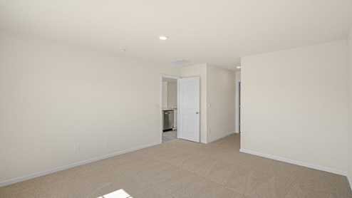 large room with carpet flooring and natural light