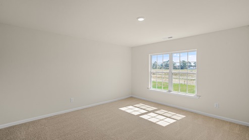 large room with carpet flooring and natural light