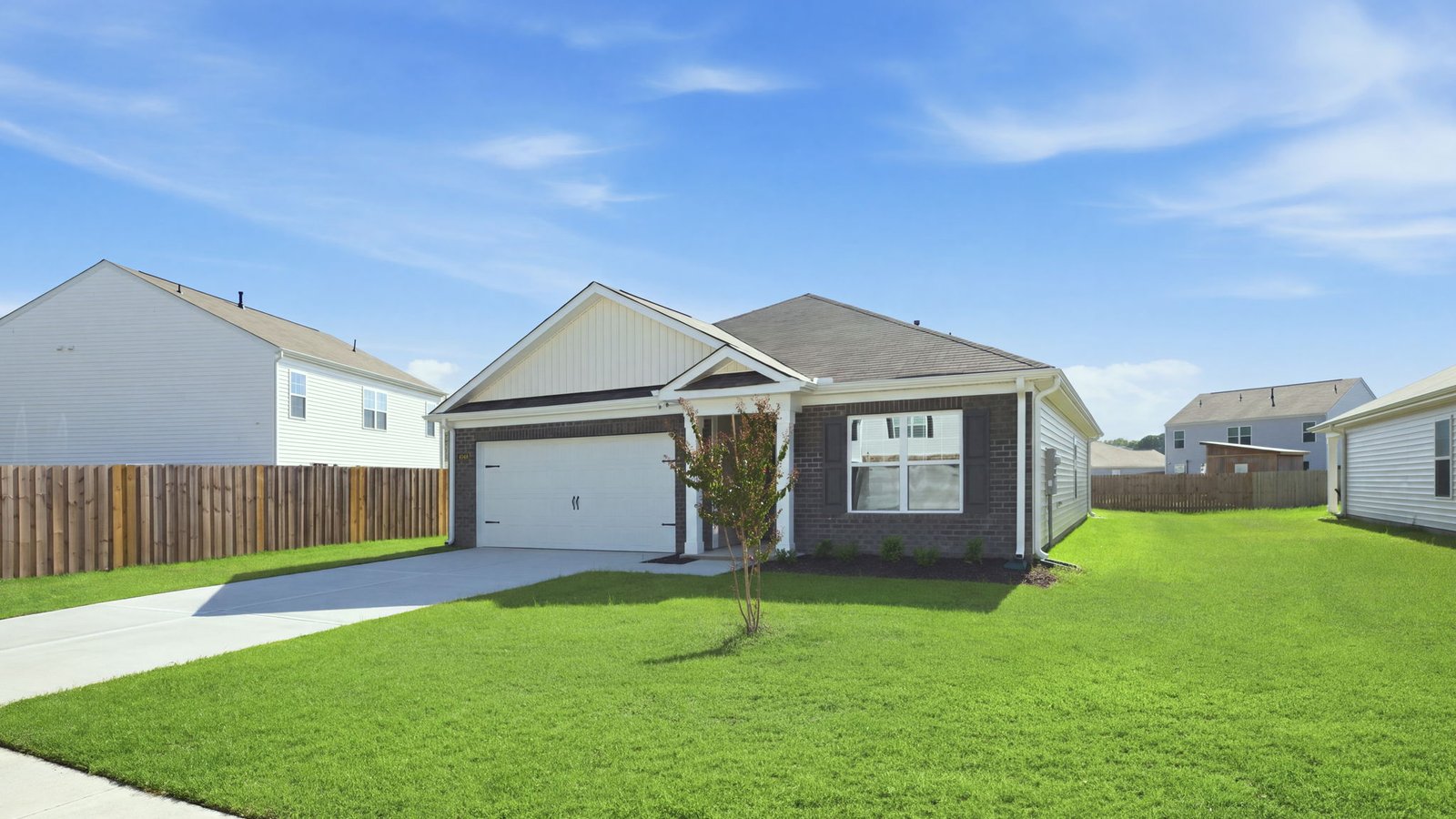front view of home with yard and driveway