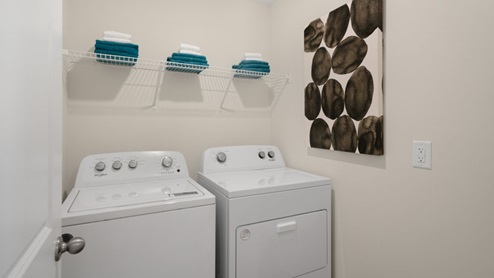 laundry room with washer and dryer with built in wire shelving