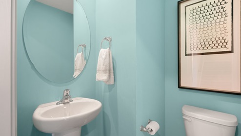 powder room with blue walls and sink and toilet
