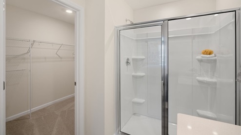 primary bathroom with double sinks and walk in shower