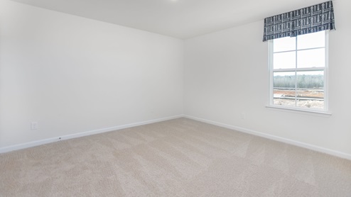 bedroom with carpet flooring and window for natural light