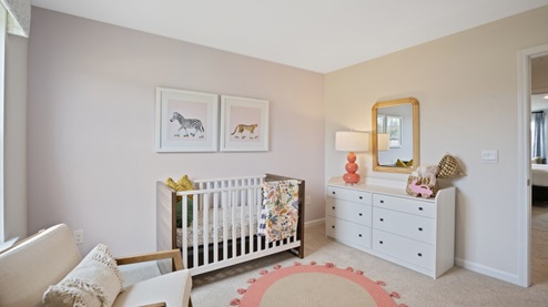 nursery with carpet and large window for natural light
