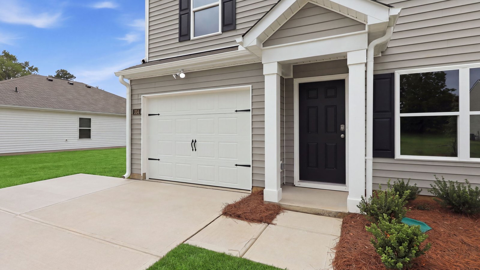front porch and driveway view with garage