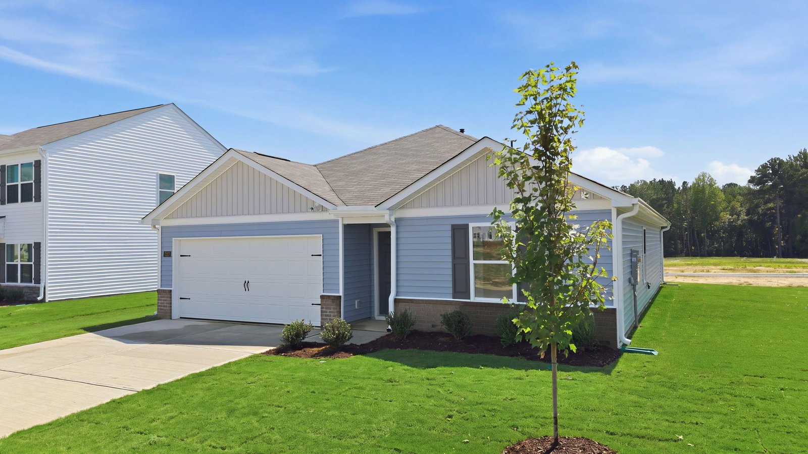 exterior of one story ranch plan with driveway and garage