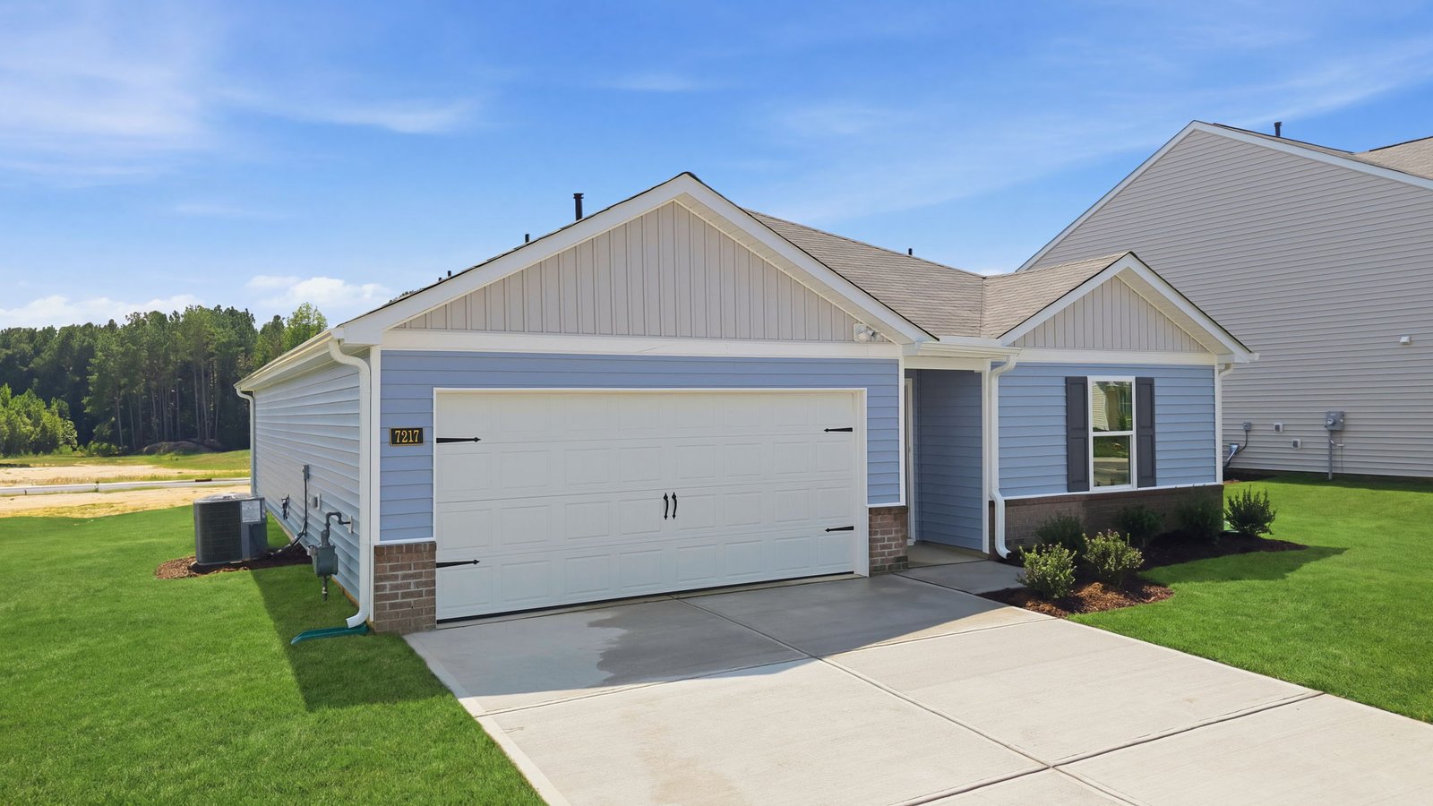 exterior of one story ranch plan with driveway and garage