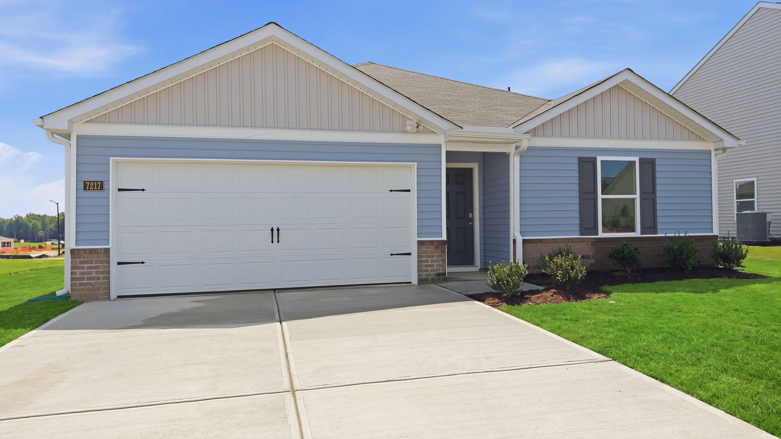 exterior of one story ranch plan with driveway and garage