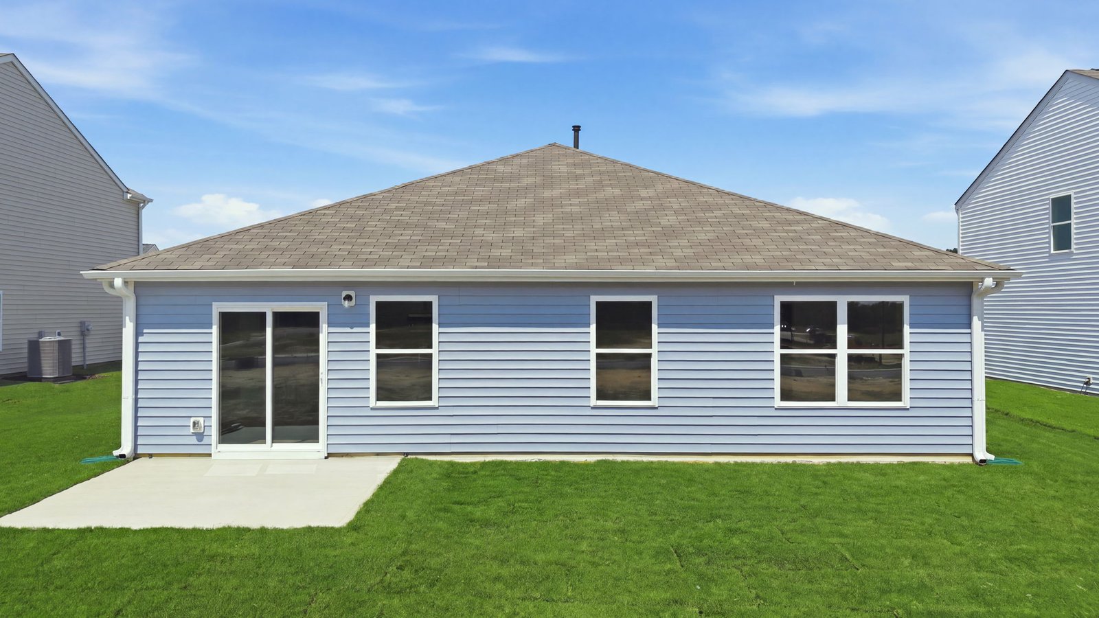 rear view of home and back yard with back patio pad